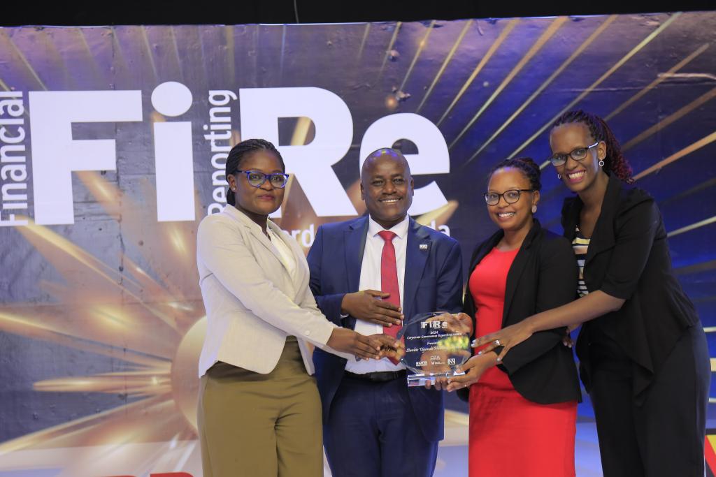 Stanbic Uganda Holdings Limited representatives posing for a photograph with their award of Winner in financial reporting under the Corporate Governance Reporting award category at the 2024 Financial Reporting (FiRe) awards.