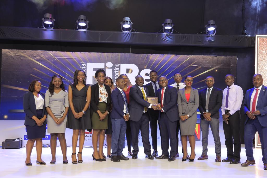 PostBank Uganda Limited representatives posing for a photograph with their bronze award in financial reporting under the Integrated Report of the Year award category at the 2024 Financial Reporting (FiRe) awards.