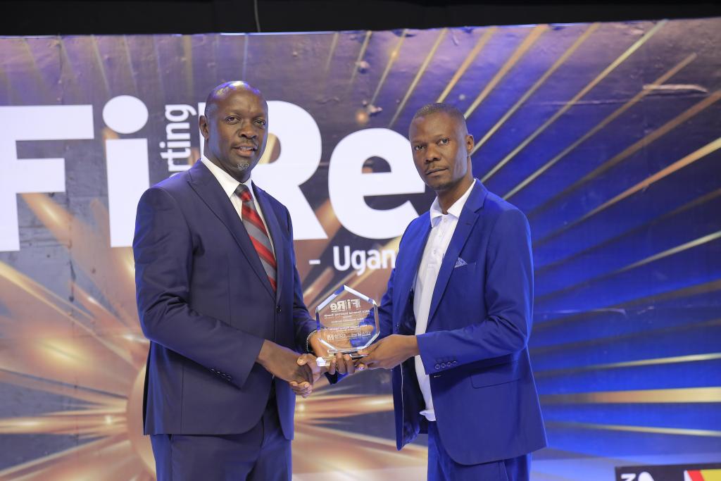 Willis Towers Watson Uganda Insurance Brokers representative posing for a photograph with their award of Winner in financial reporting under the other Insurance Services category at the 2024 Financial Reporting (FiRe) awards.