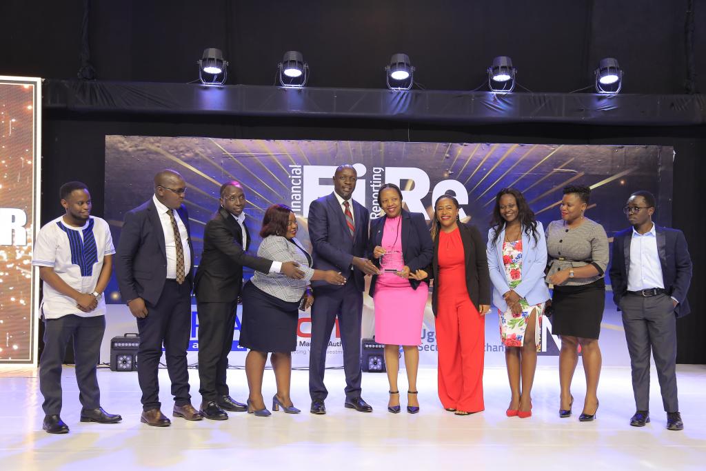 Liberty Life Assurance Uganda Limited representatives posing for a photograph with their award of Winner in financial reporting under the Insurance Companies – Life Business category at the 2024 Financial Reporting (FiRe) awards.