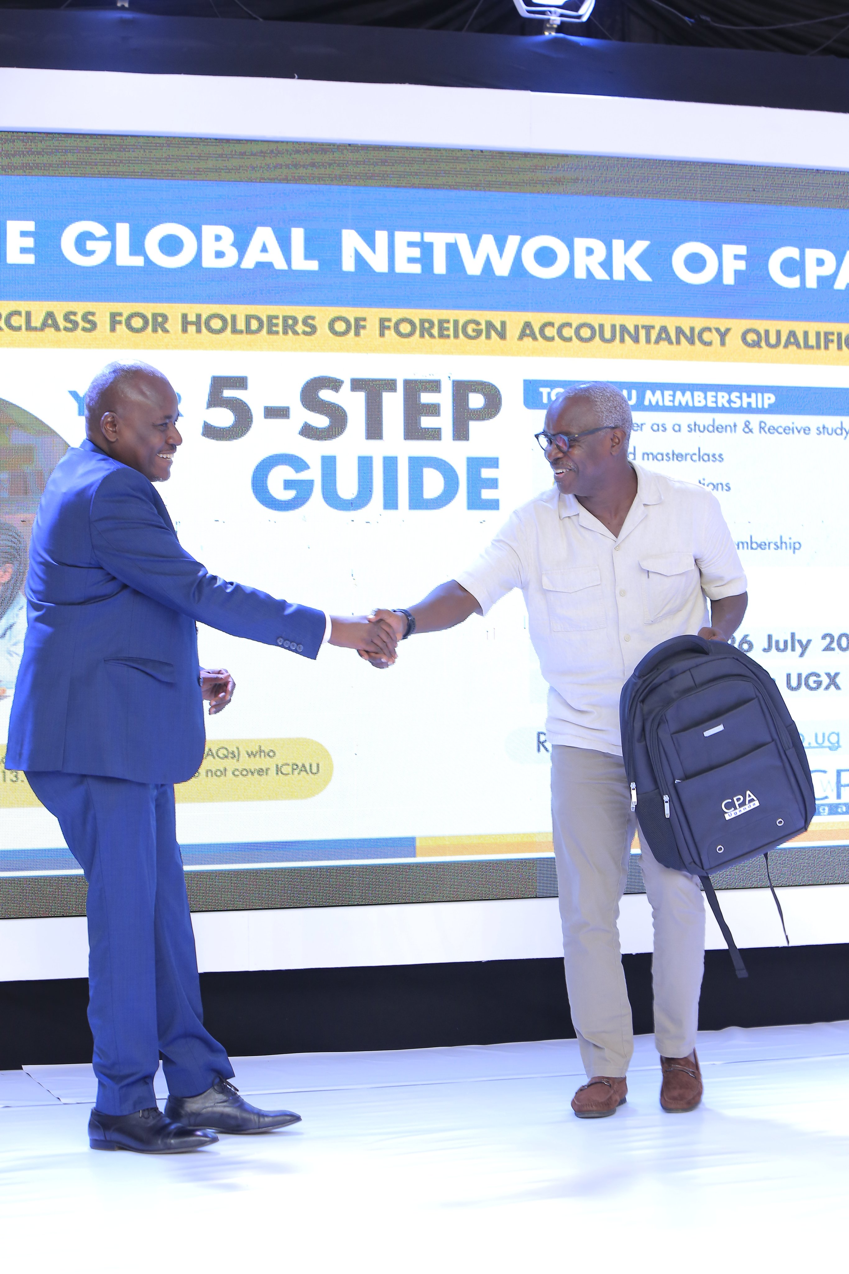 The Vice President ICPAU Council, CPA Ronald Mutumba (left) the  CEO ICPAU, CPA Derick hands over tokens of appreciation to Mr. Robert Kabushenga(left) he moderator for the 2nd C-Suite Forum.