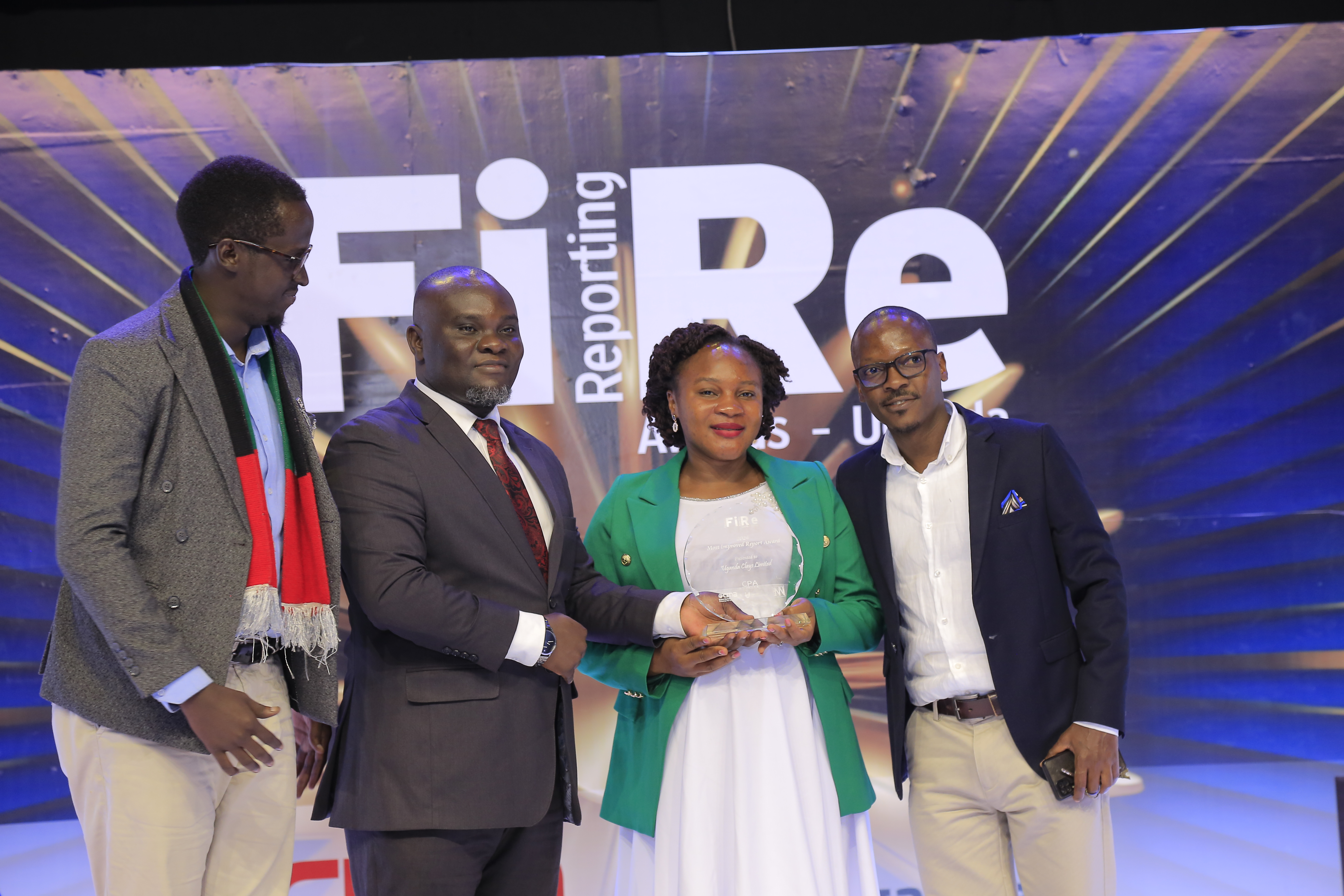 Uganda Clays Limited representatives posing for a photograph with their award of Winner in financial reporting under the Most Improved Report award category at the 2024 Financial Reporting (FiRe) awards.