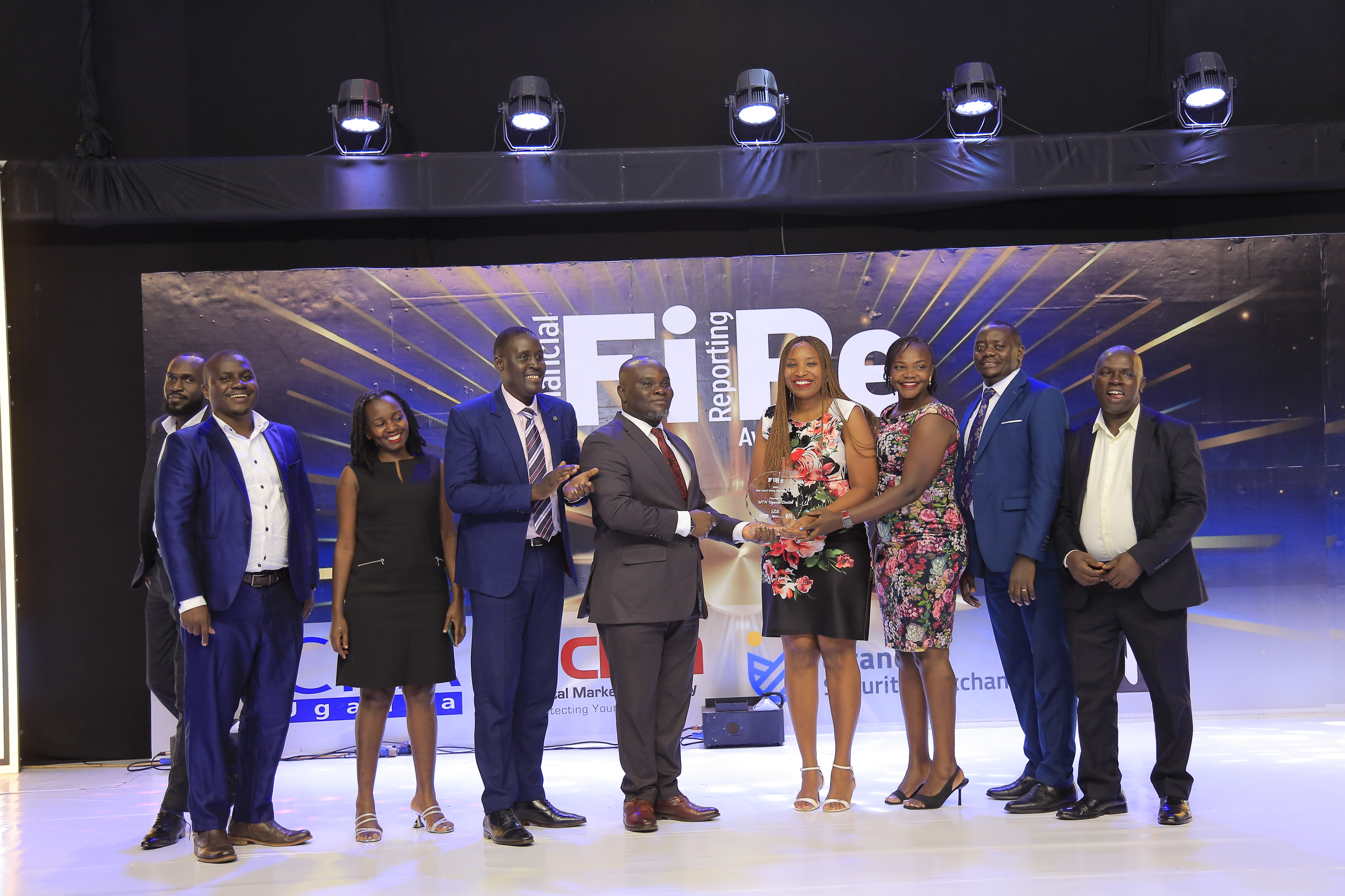 MTN Uganda Limited representatives posing for a photograph with their award of Winner in financial reporting under the Presentation and communication award category at the 2024 Financial Reporting (FiRe) awards.