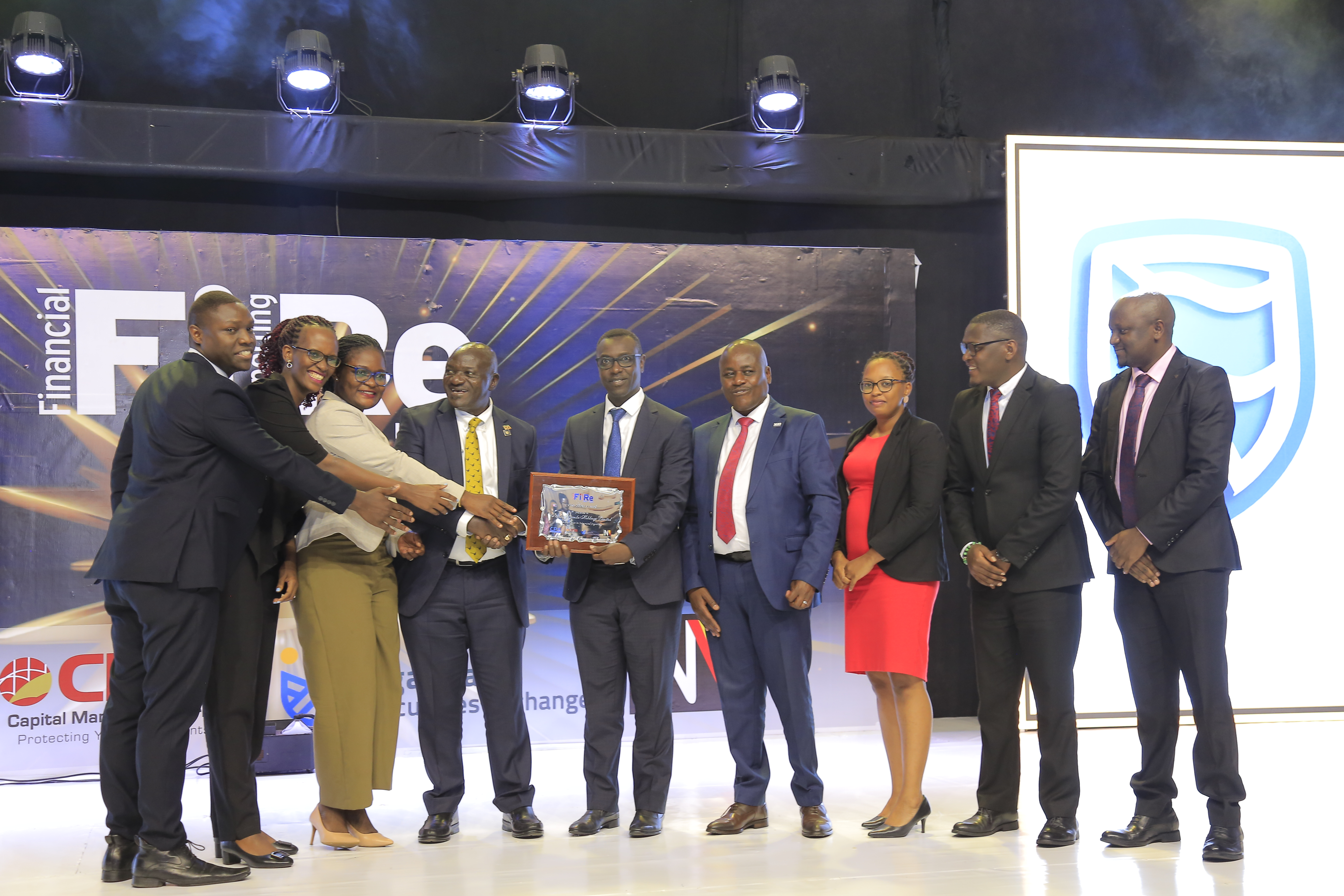 Stanbic Uganda Holdings Limited representatives posing for a photograph with their silver award in financial reporting under the Integrated Report of the Year award category at the 2024 Financial Reporting (FiRe) awards.