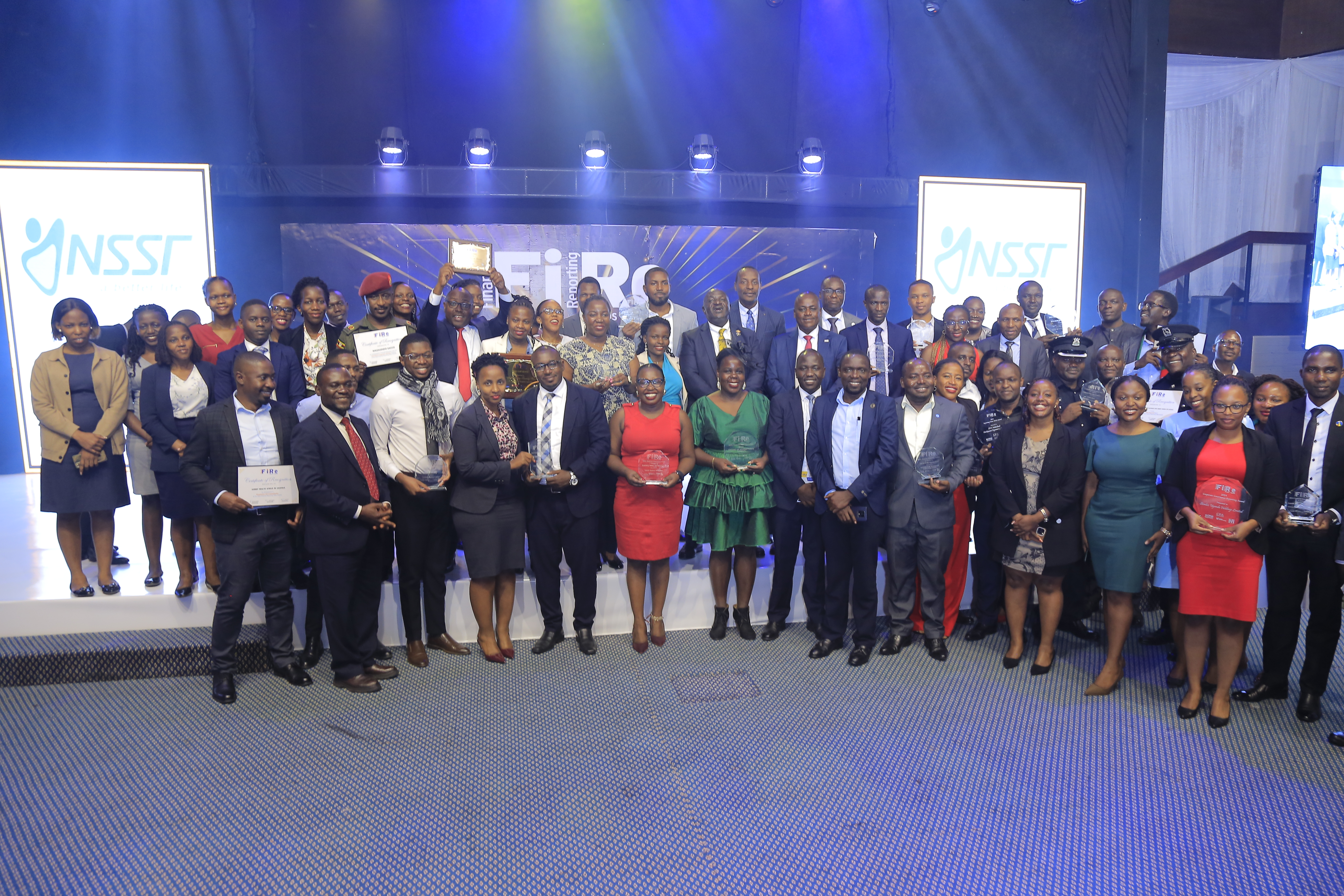 A group photo of all the winning entities posing with their awards at the 2024 Financial Reporting (FiRe) awards on 6 November 2024 at Serena Hotel Kampala.