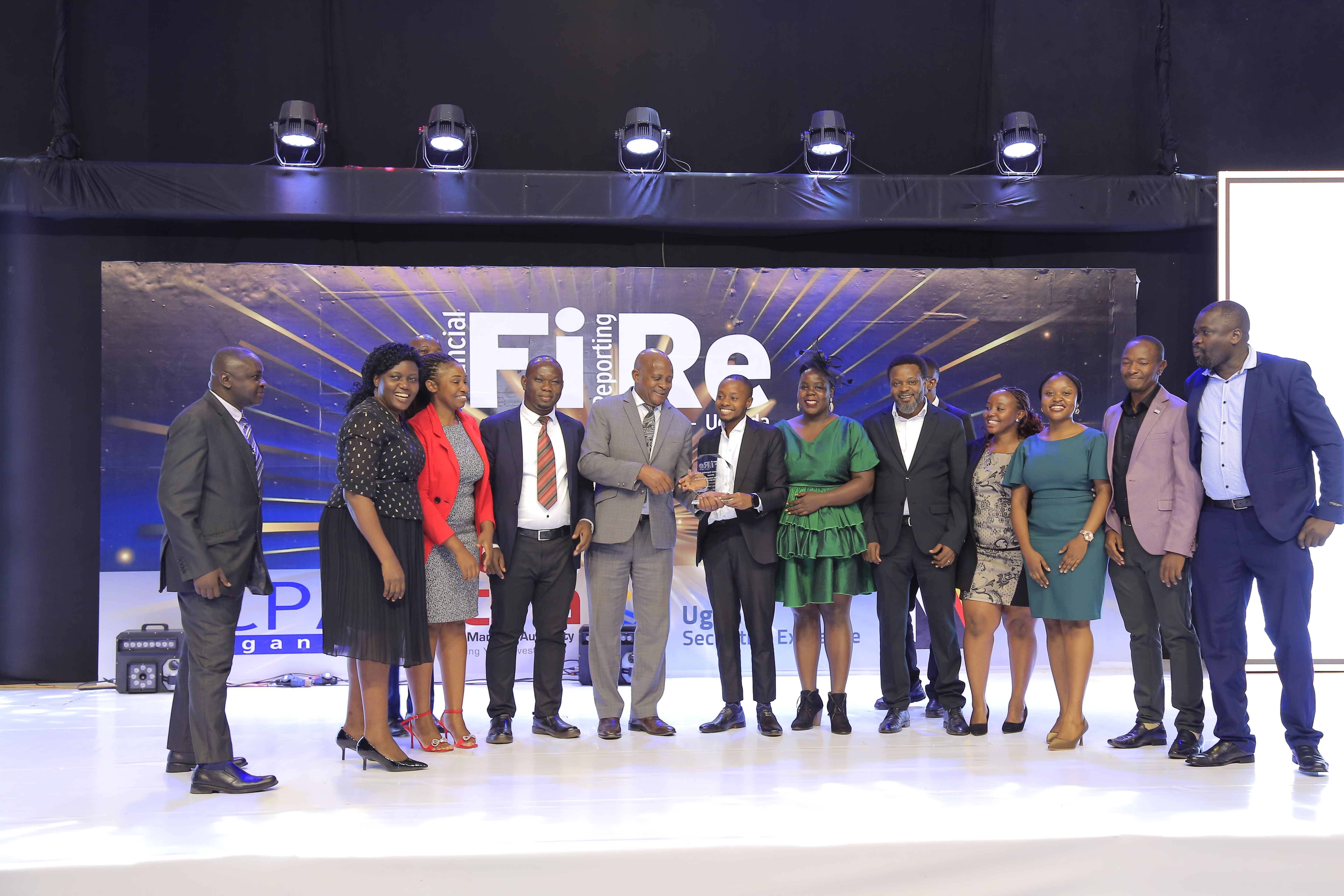 Umeme Limited representatives posing for a photograph with their award of Winner in financial reporting under the consumer and industrial products Category A at the 2024 Financial Reporting (FiRe) awards.