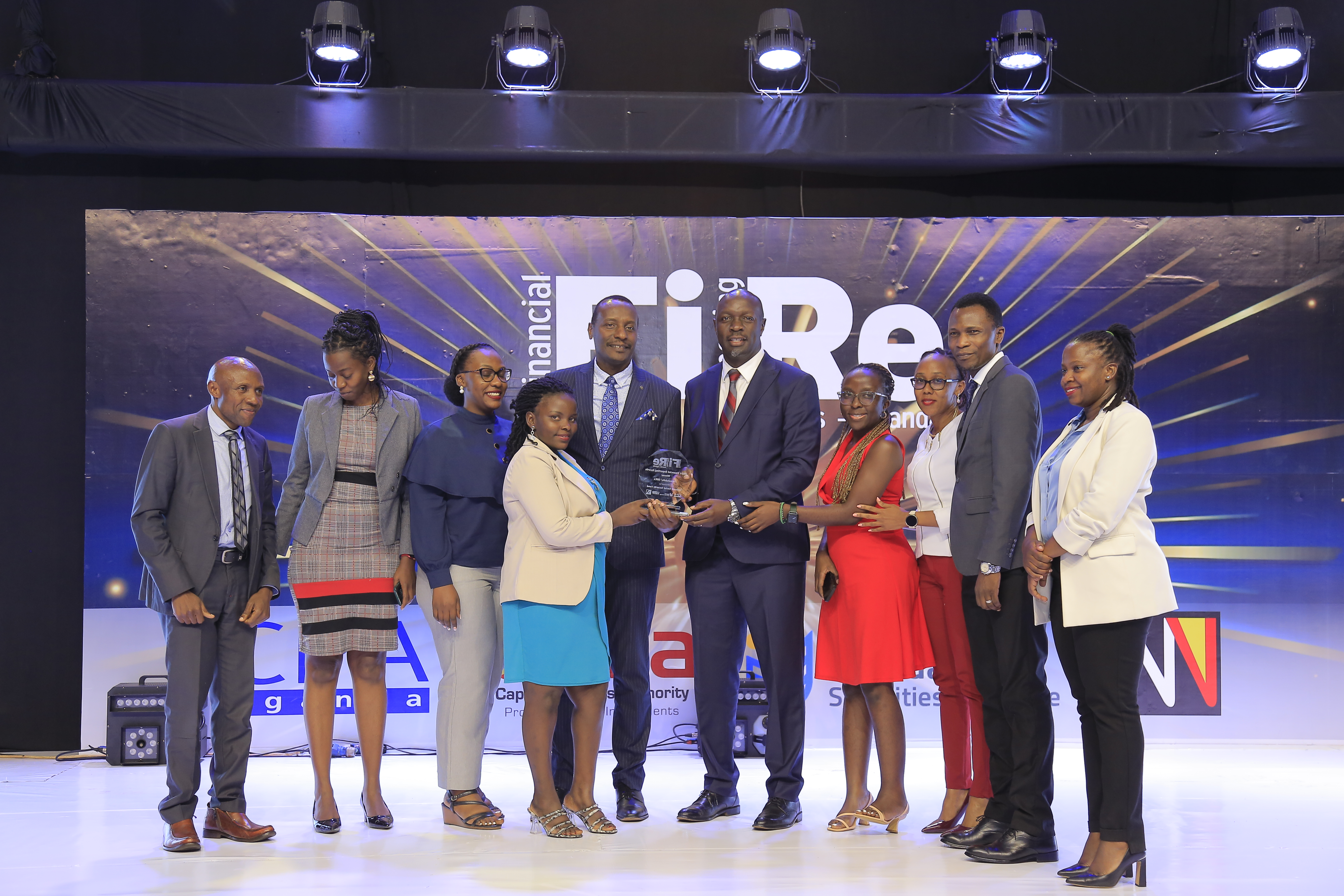 National Social Security Fund representatives posing for a photograph with their award of Winner in financial reporting under the parastatals/GBEs category at the 2024 Financial Reporting (FiRe) awards.