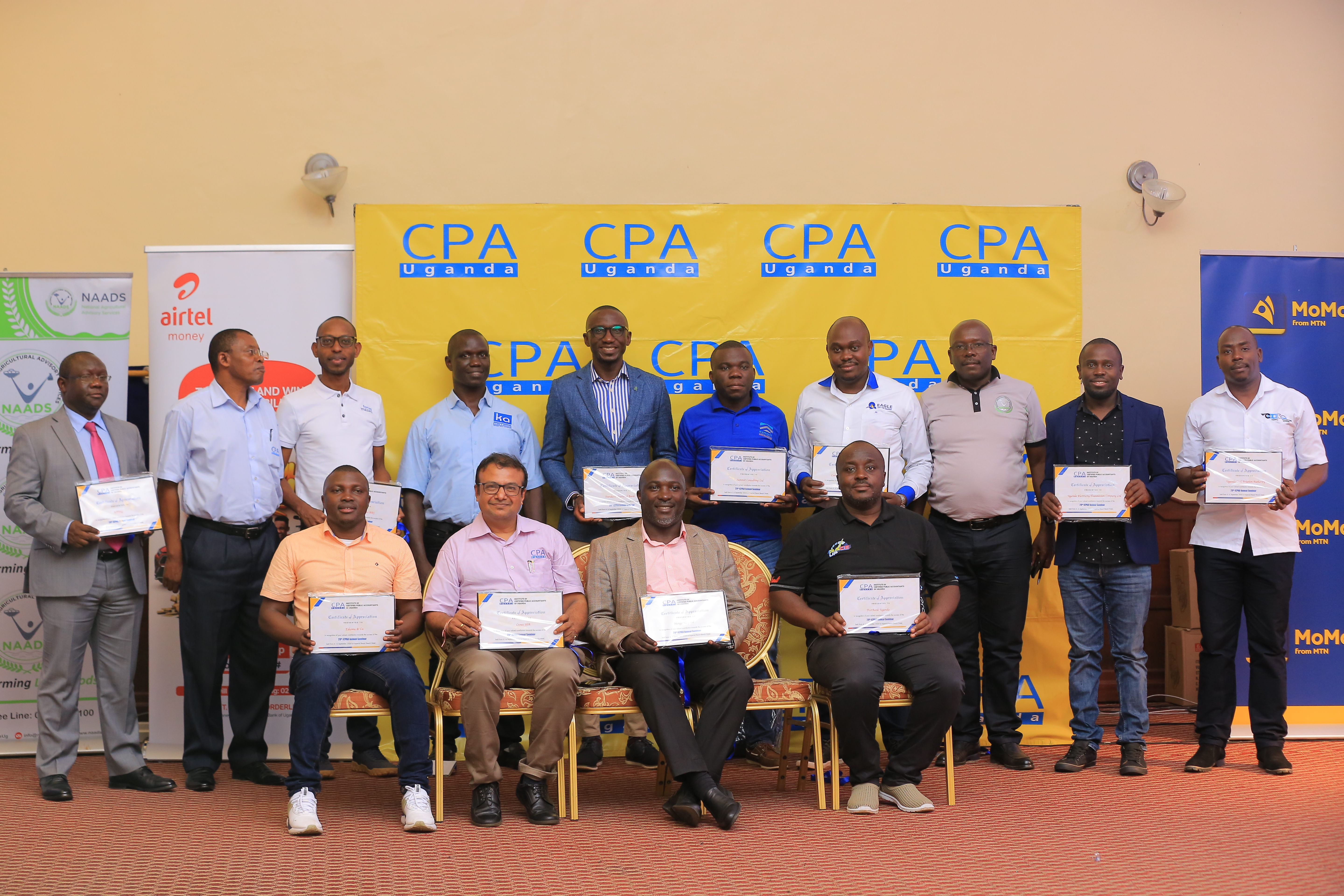 Picture moment: Some partners of the 29th ICPAU Annual Seminar pose with their certificates of appreciation with CPA Derick Nkajja, ICPAU CEO (2nd  L)