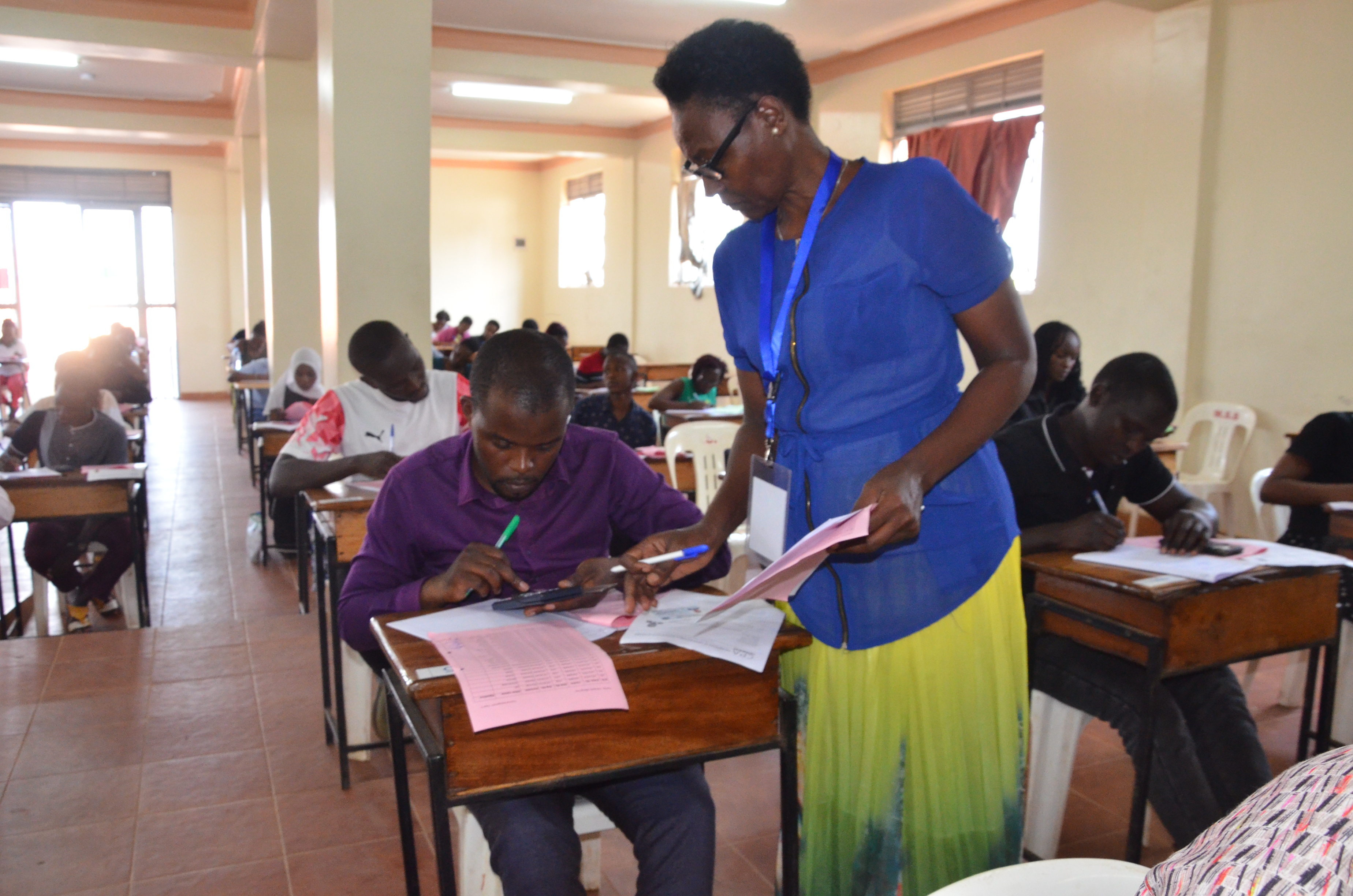 An invigilator roll-calling and registering students during the December 2024 examinations held at Mengo SS at the Kampala centre